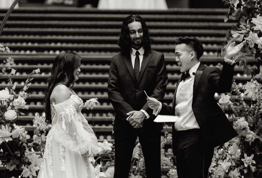 Bride throwing vows as he speaks in front of bride at the arcade wedding ceremony