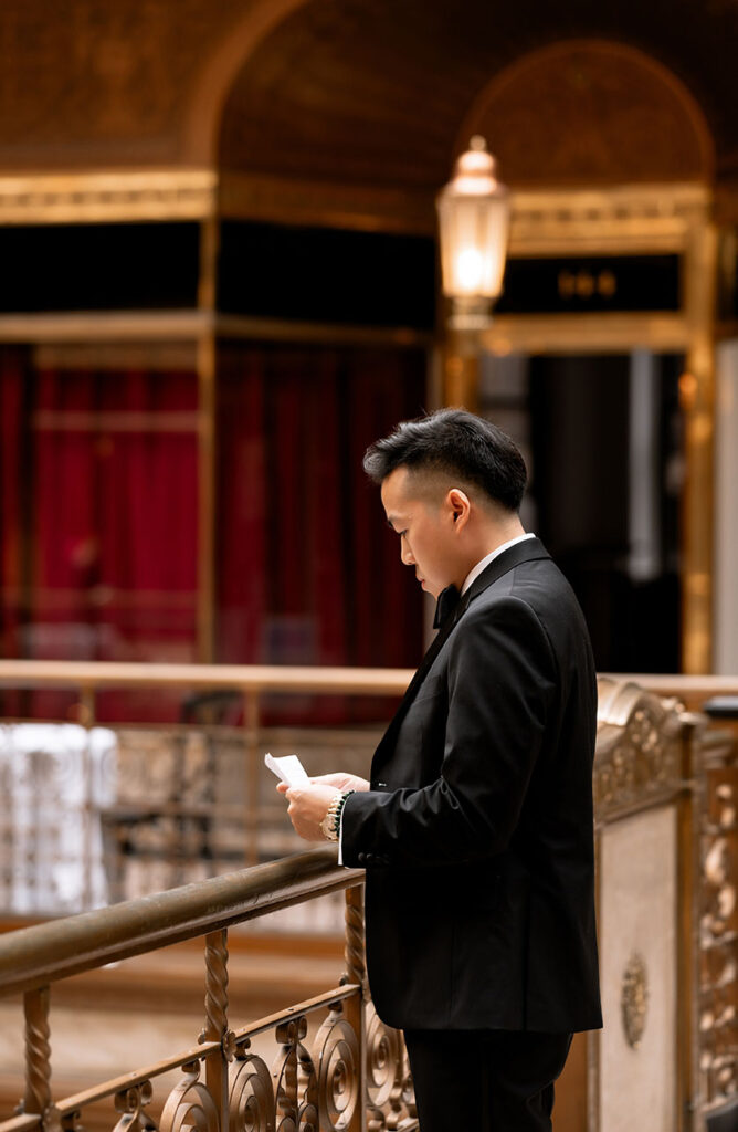 Groom reading his vows at the arcade