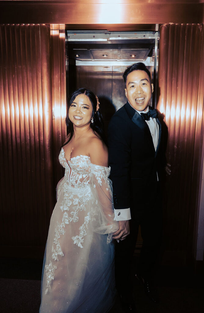 Bride and Groom at an elevator during their wedding at the Arcade