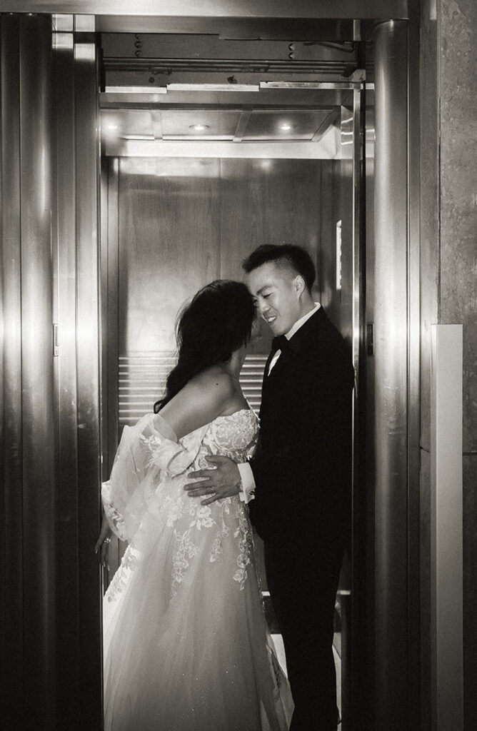 Bride and Groom at an elevator during their wedding at the Arcade