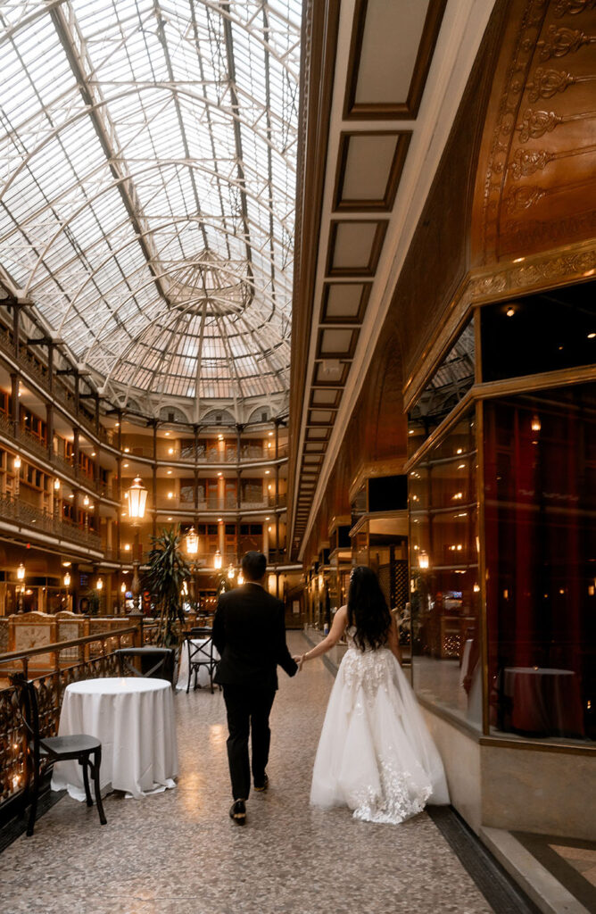 Bride and Groom walking at the Arcade