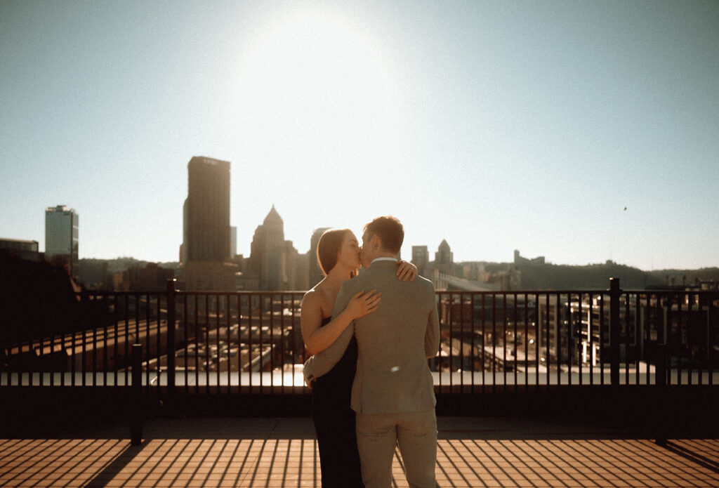 Couple kissing with Pittsburgh Skyline in the back