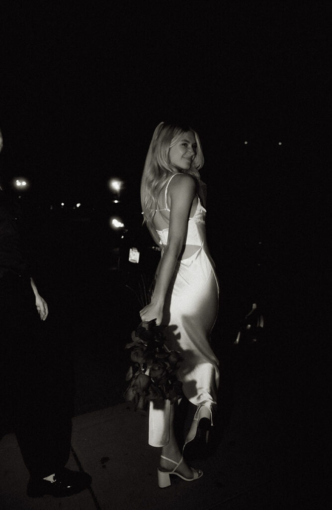 Bride looking while walking with bouquet