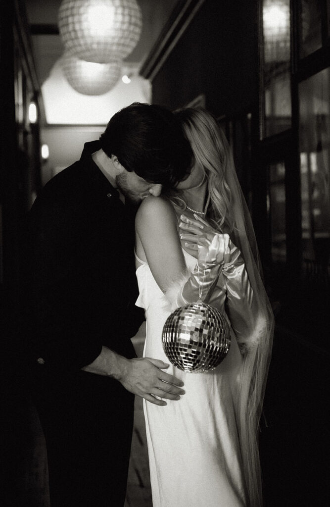 Groom and Bride with disco ball at their artsy elopement