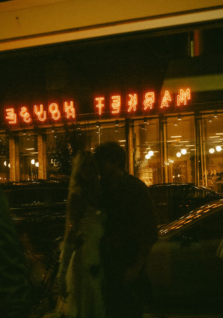 Couple looking at their reflection at night on their eloping day