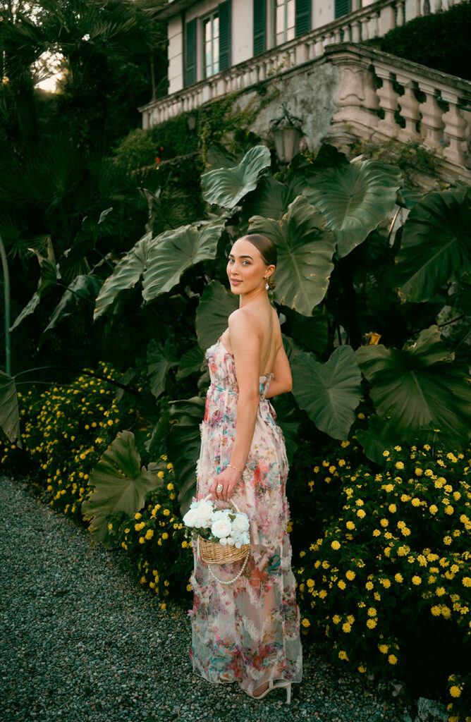 Young Woman in front of green plants at Villa Carlotta in Lake Como