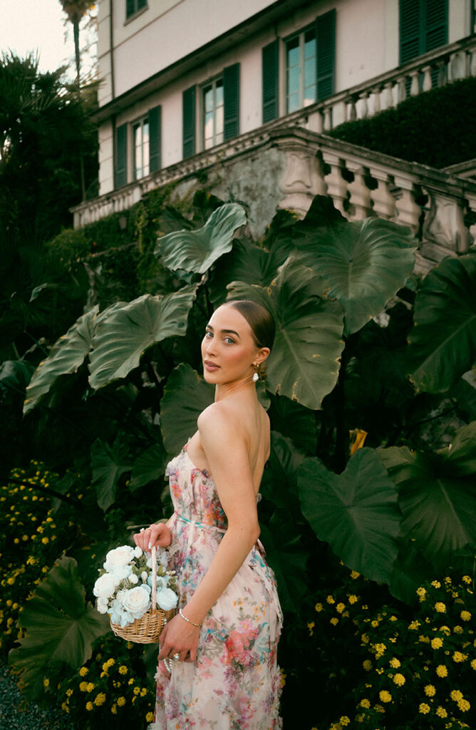 Young Woman in front of green plants at Villa Carlotta in Lake Como