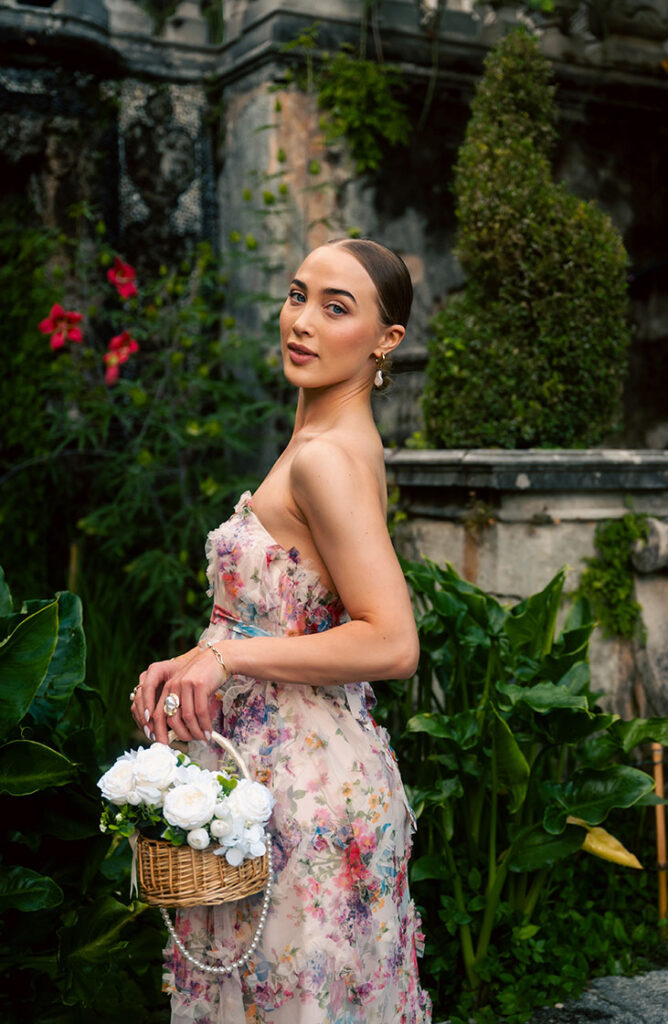 Young Woman in front of green plants at Villa Carlotta in Lake Como