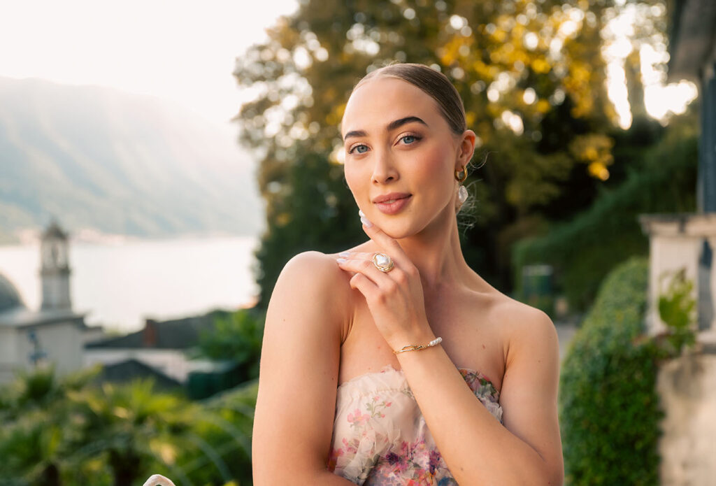 Young Woman in front of green plants at Villa Carlotta in Lake Como