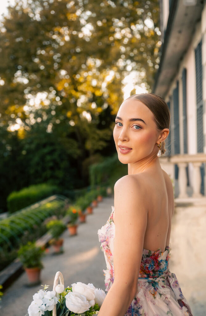 Young Woman in front of green plants at Villa Carlotta in Lake Como