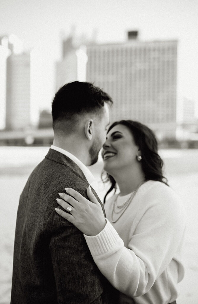 BW Engaged couple showing off engagement ring