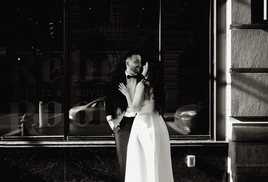 Couple Stand by a window of the Industrialist Hotel