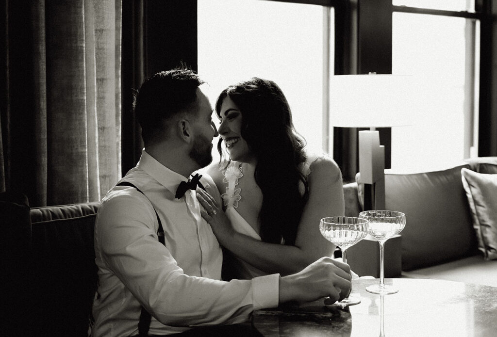 BW Bride and Groom at the Industrialist Bar drinking champagne