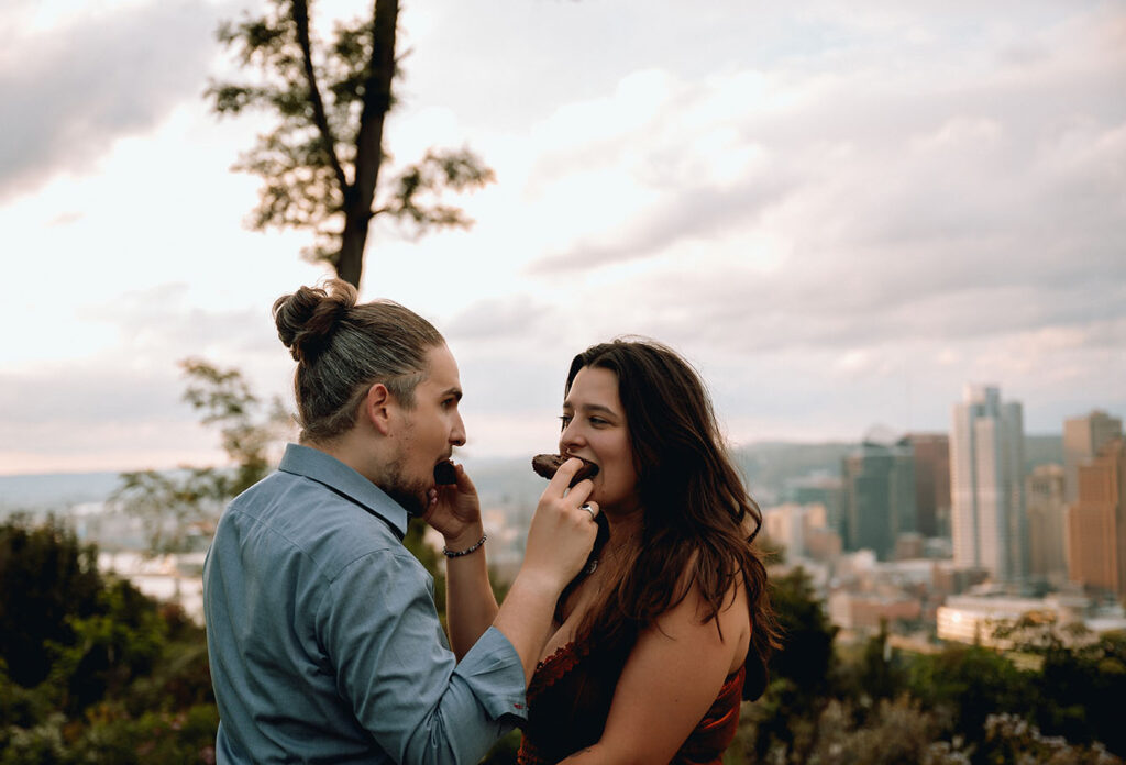 Couple feeding each other during anniversary photo shoot