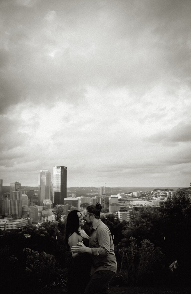 Couple kiss with Pittsburgh Skyline in the background