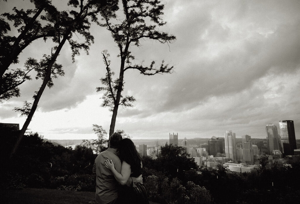 Couple embraced each other while they look at Pittsburgh's skyline