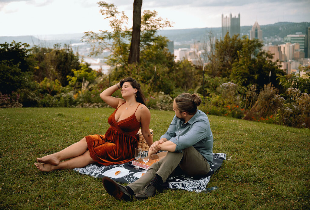 Couple have a picnic at Emerald Park for their anniversary engagement