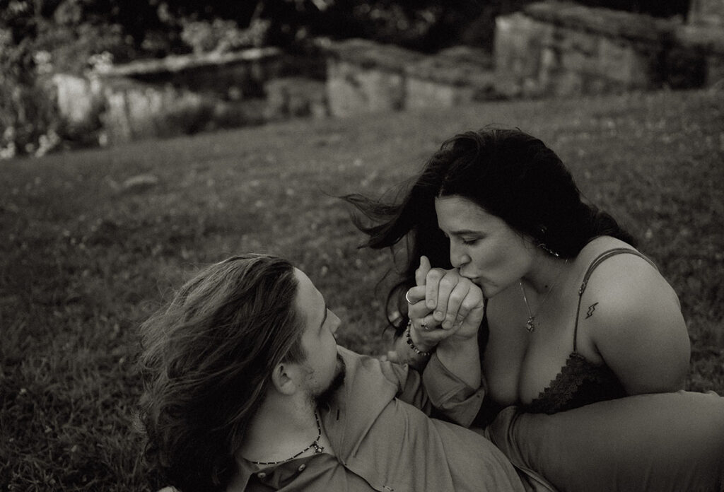 Woman Kissing partner's hand during anniversary photo shoot at Emerald Park