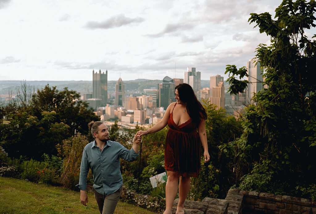 Couple walking with Pittsburgh Skyline in the back