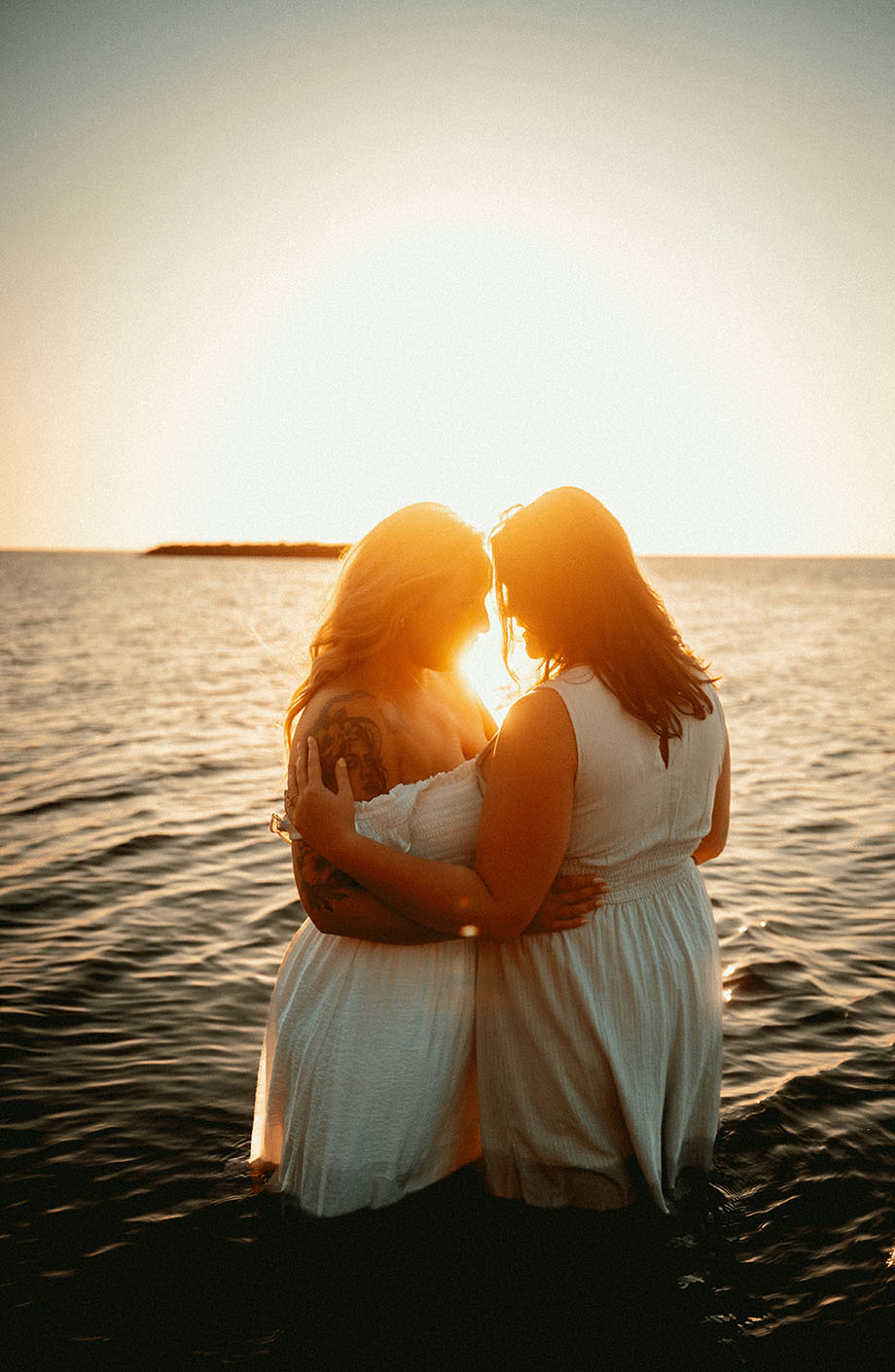 Engaged Couple Holding each other in the sand at Presque Isle