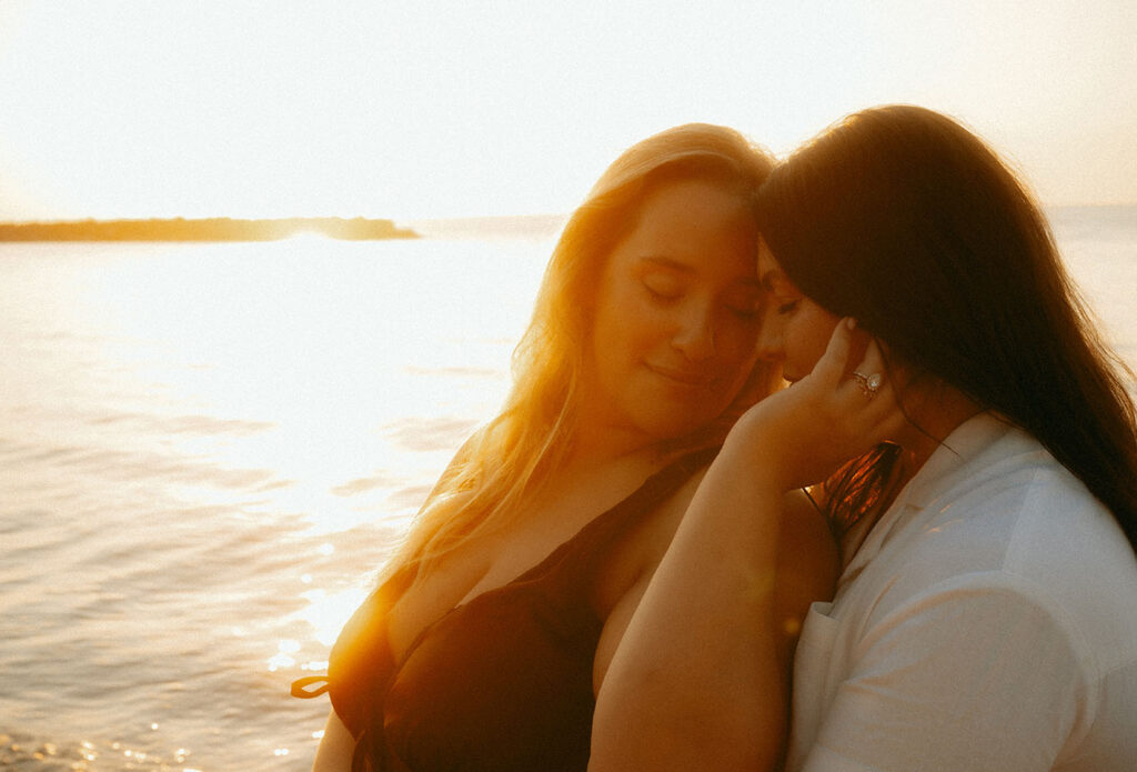 Same sex couple holding each other at Presque Isle in Erie PA