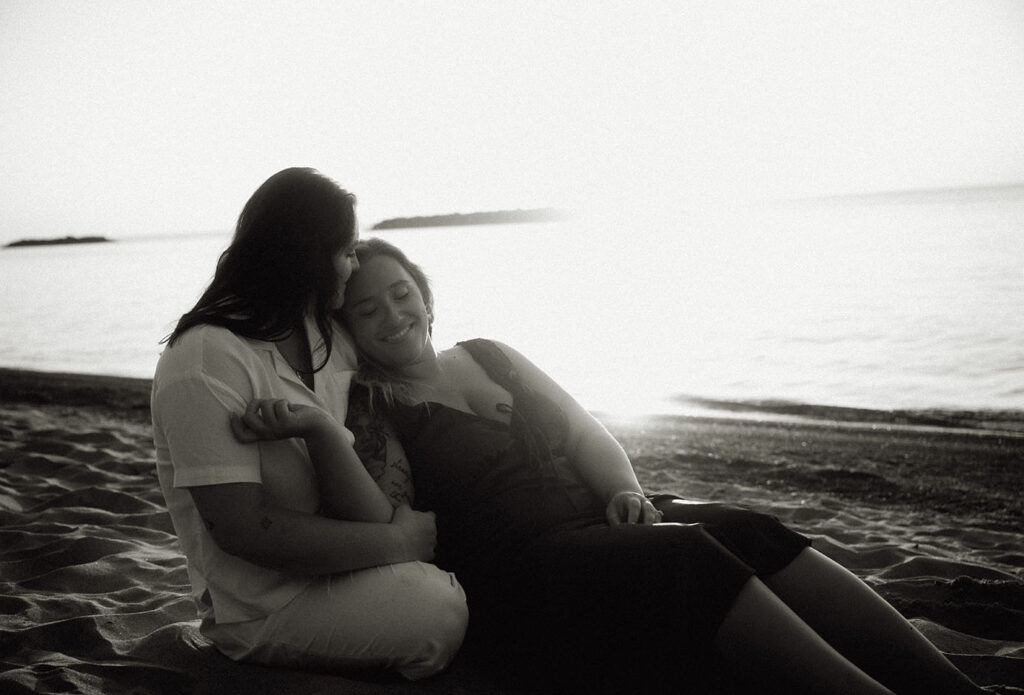 Engaged Couple Holding each other in the sand at Presque Isle