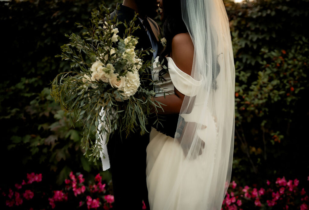 Bride and Groom Under Veil Kissing