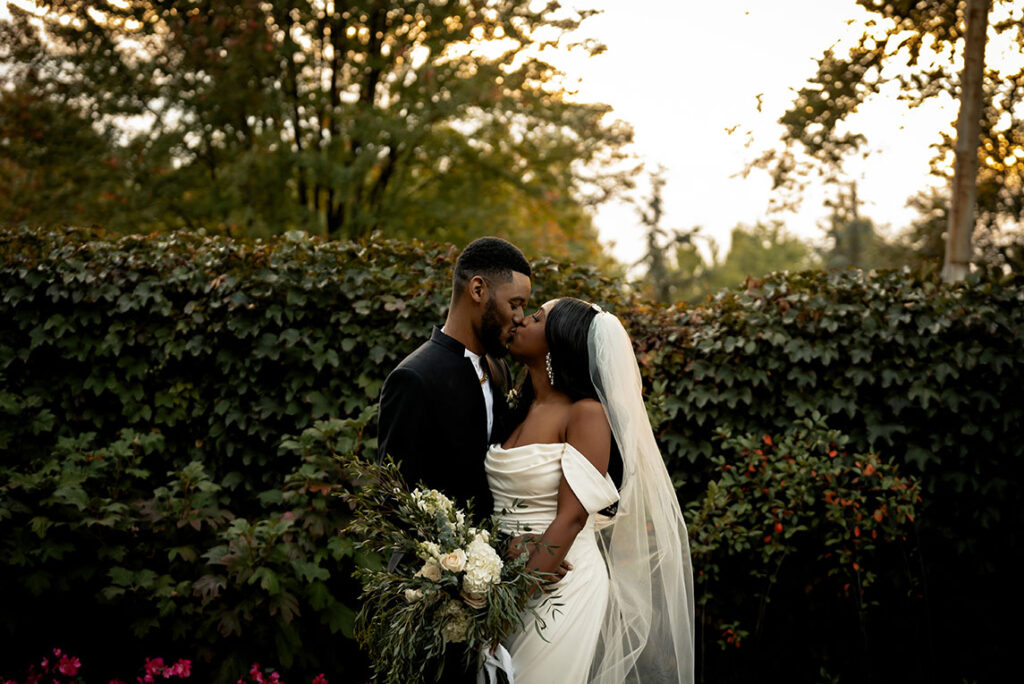 Bride and Groom Kiss during sunset at their wedding at the National Aviary