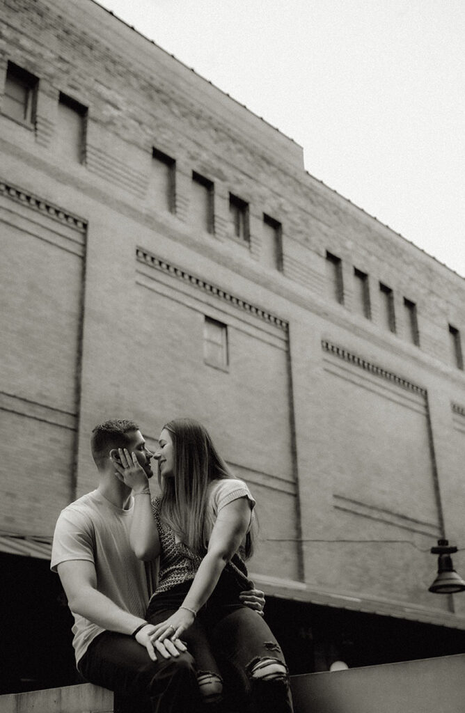 Playful documentary-style engagement photo at The Highline, showing Pittsburgh’s iconic bridges and skyline.