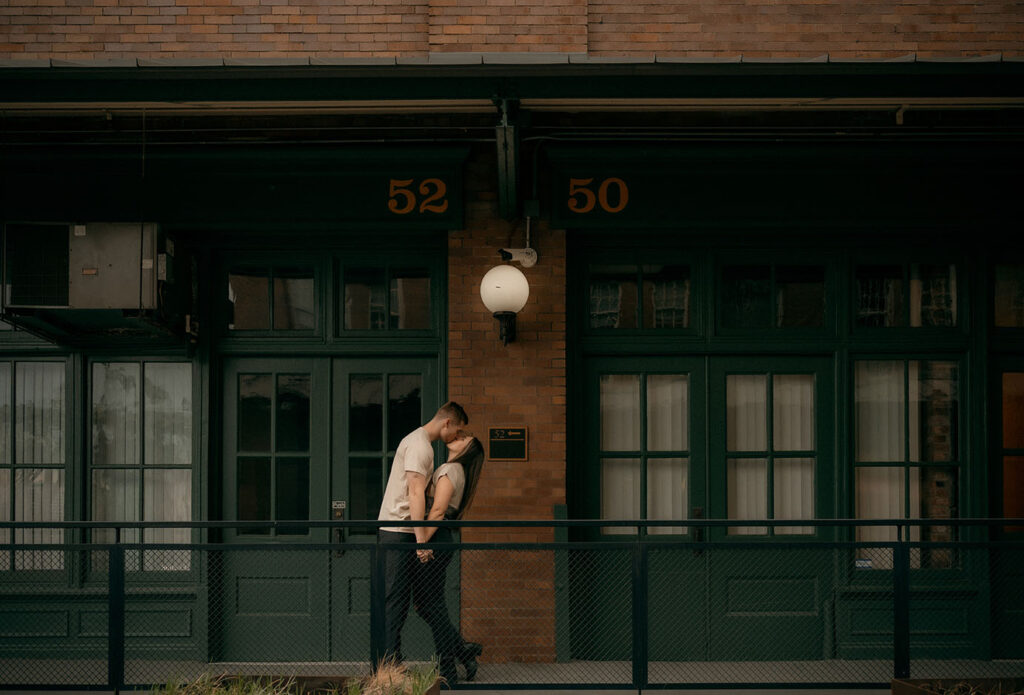 Artistic engagement photo of a couple in front of Pittsburgh’s downtown skyline from The Highline bridge platform.