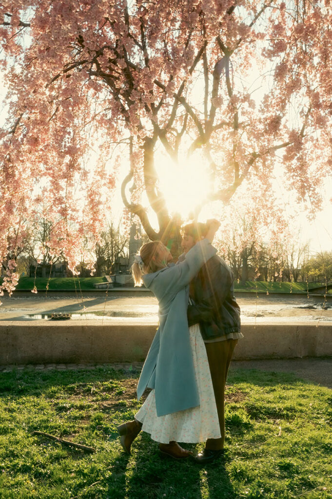 Candid moment of couple laughing together during a documentary-style engagement session at Allegheny Commons Park in Pittsburgh.