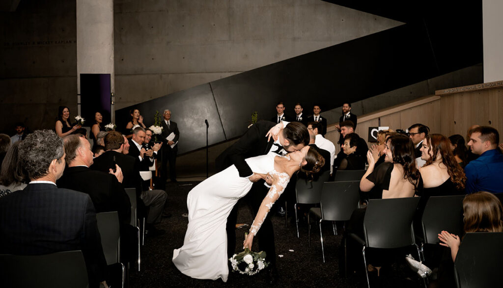 Bride and groom kiss during wedding ceremony at the Cincinnati contemporary art museum