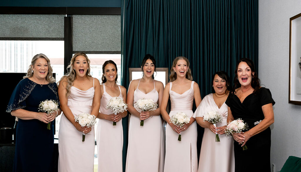 Bridesmaids reacting when they see bride for the first time