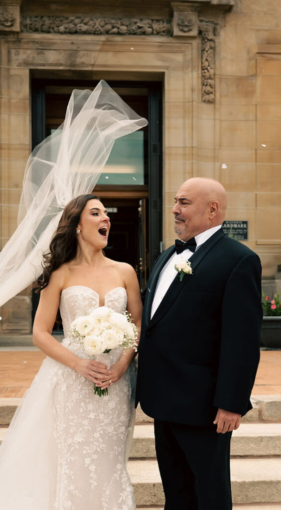 Bride with her father and her veil in the wind