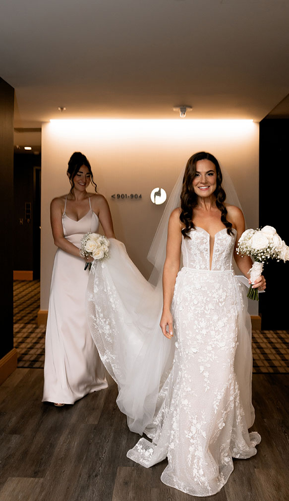 Bride walking out with her maid of honor at the Oaklander Hotel