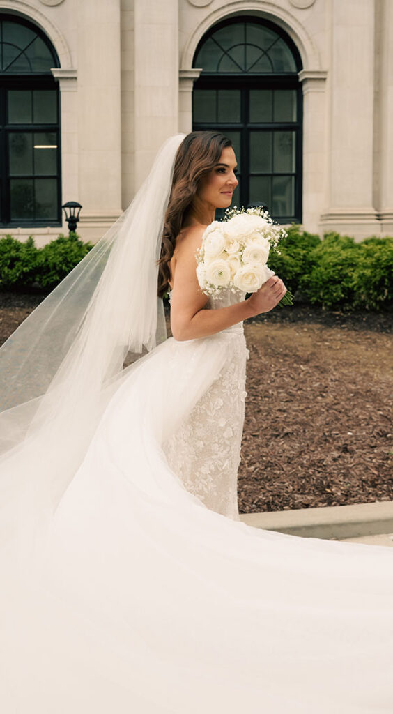 Classy Bride holding her white bridal bouquet