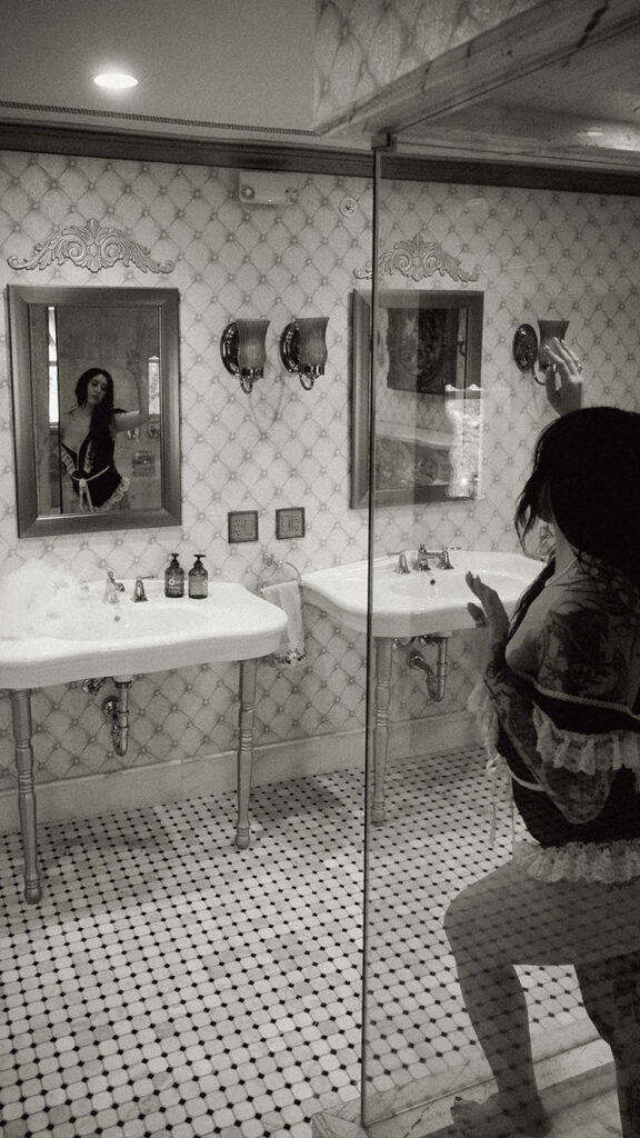 Woman holding hair during her boudoir photos at chateau connellsville