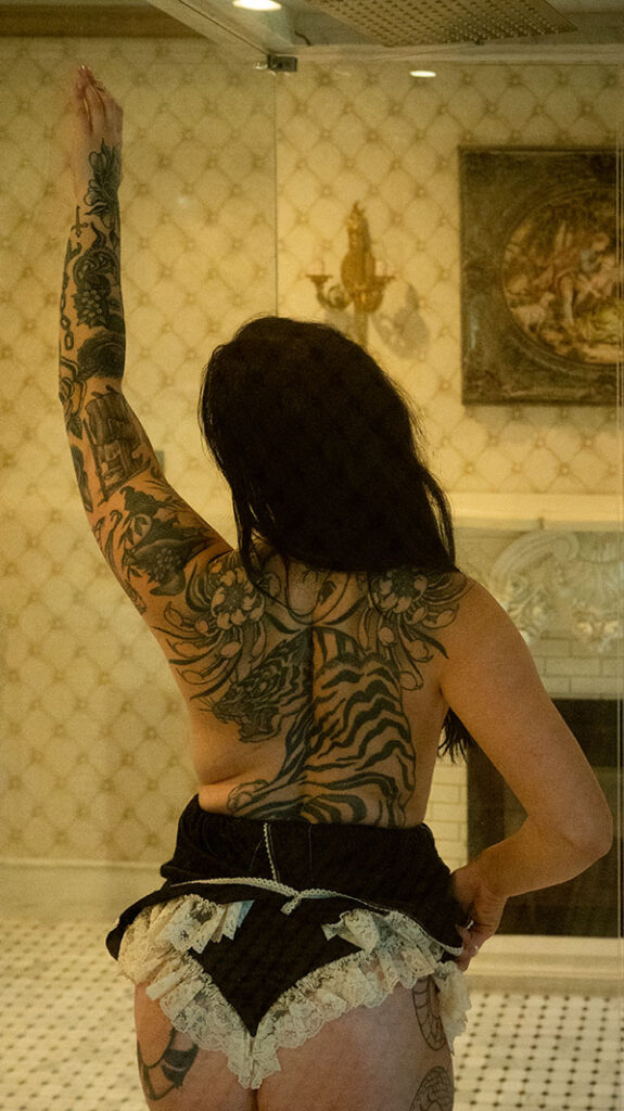 Woman holding hair during her boudoir photos at chateau connellsville