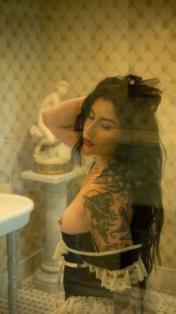 Woman holding hair during her boudoir photos at chateau connellsville