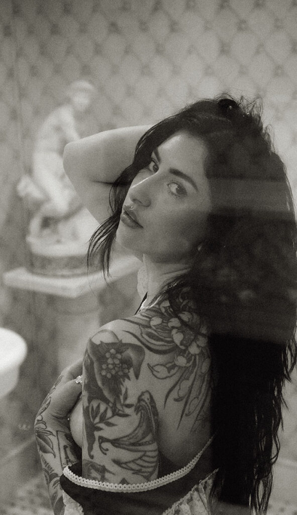 Woman holding hair during her boudoir photos at chateau connellsville