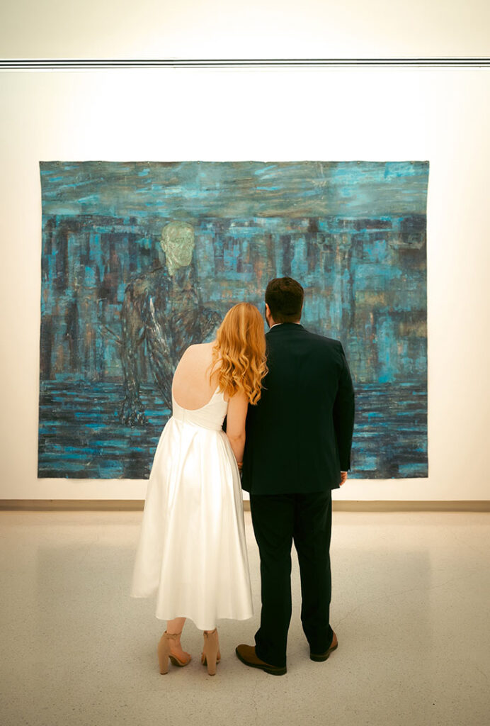 Couple embrace at their engagement in Carnegie Museum of Art