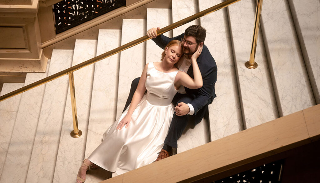 Couple sit down in the grand staircase at Carnegie Museum of Art in Pittsburgh