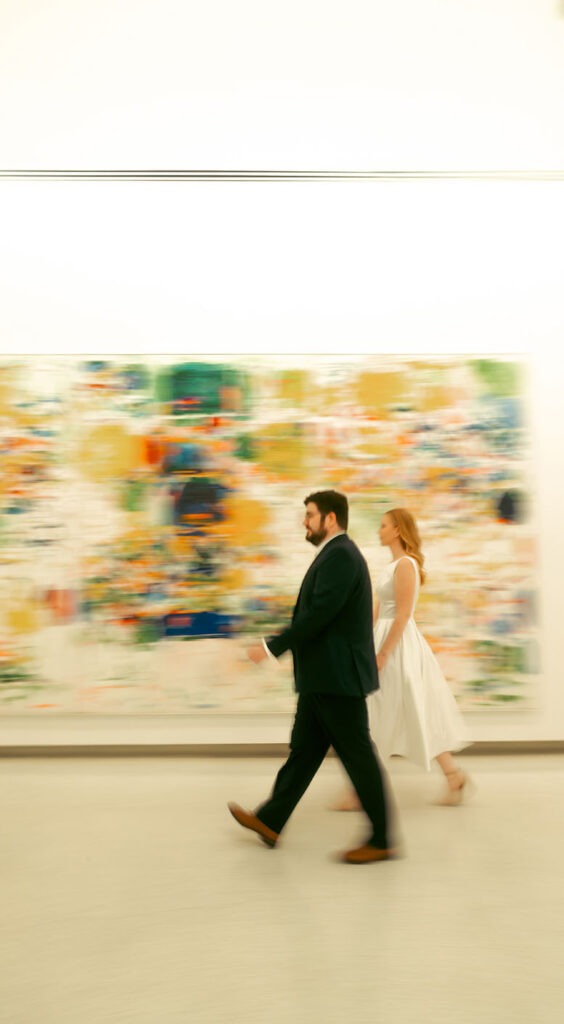 Couple Walk through art work at Carnegie Museum of Art Engagement
