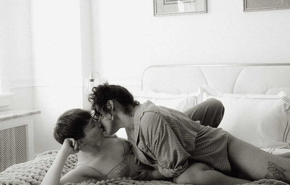 BW Couple Kiss During their none traditional Intimate boudoir Engagement Session 