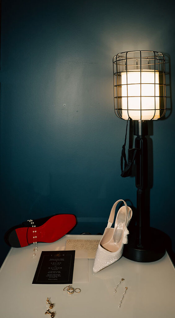 Flat Lay Photo of wedding invitation, shoes and rings at Hotel Indigo