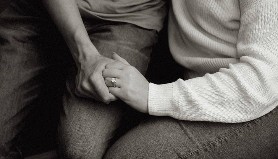 BW Couple Holding hands showing off engagement ring 