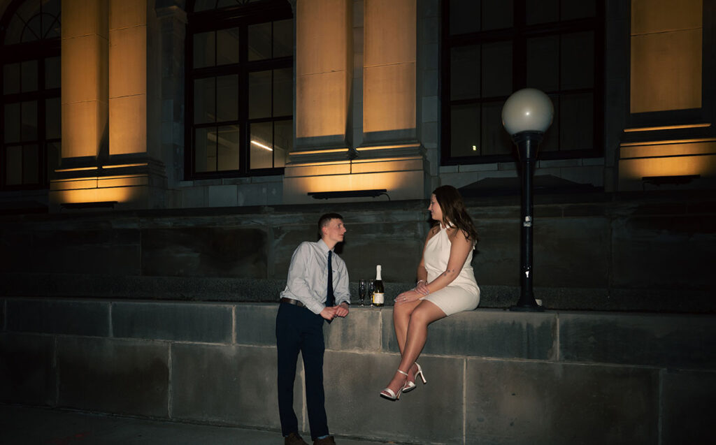 Couple sitting at night during summer engagement