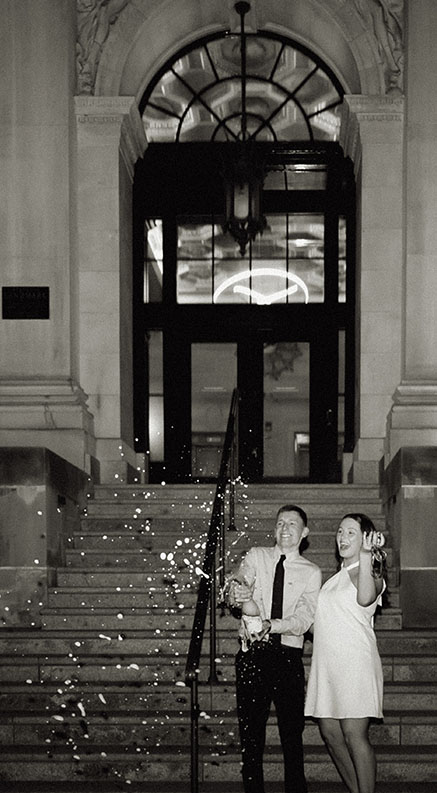 BW Couple popping champagne bottle during their romantic engagement