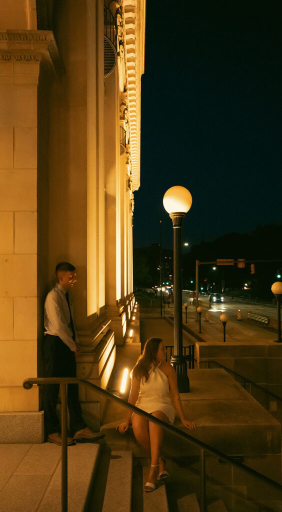 Couple sitting in Oakland during their romantic engagement in Pittsburgh