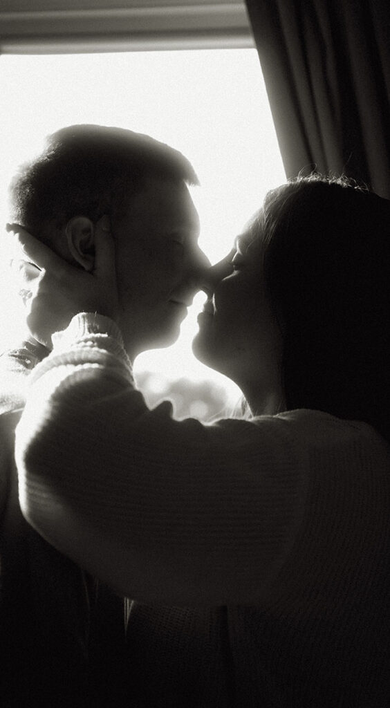 Couple about to kiss during at home Engagement